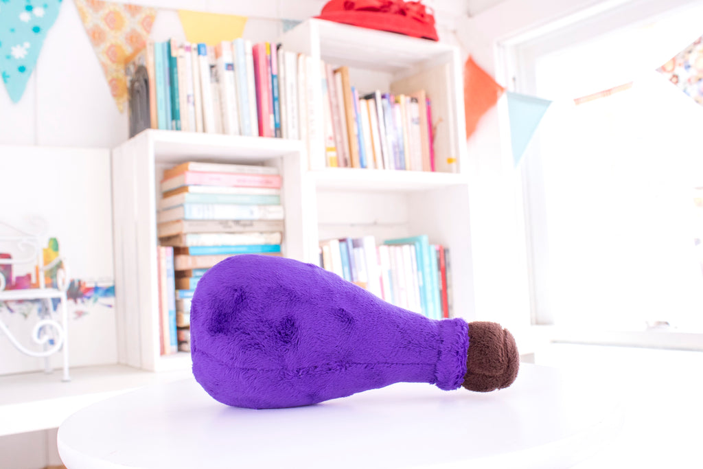 Purple teardrop shaped potion bottle plush toy with a brown top.