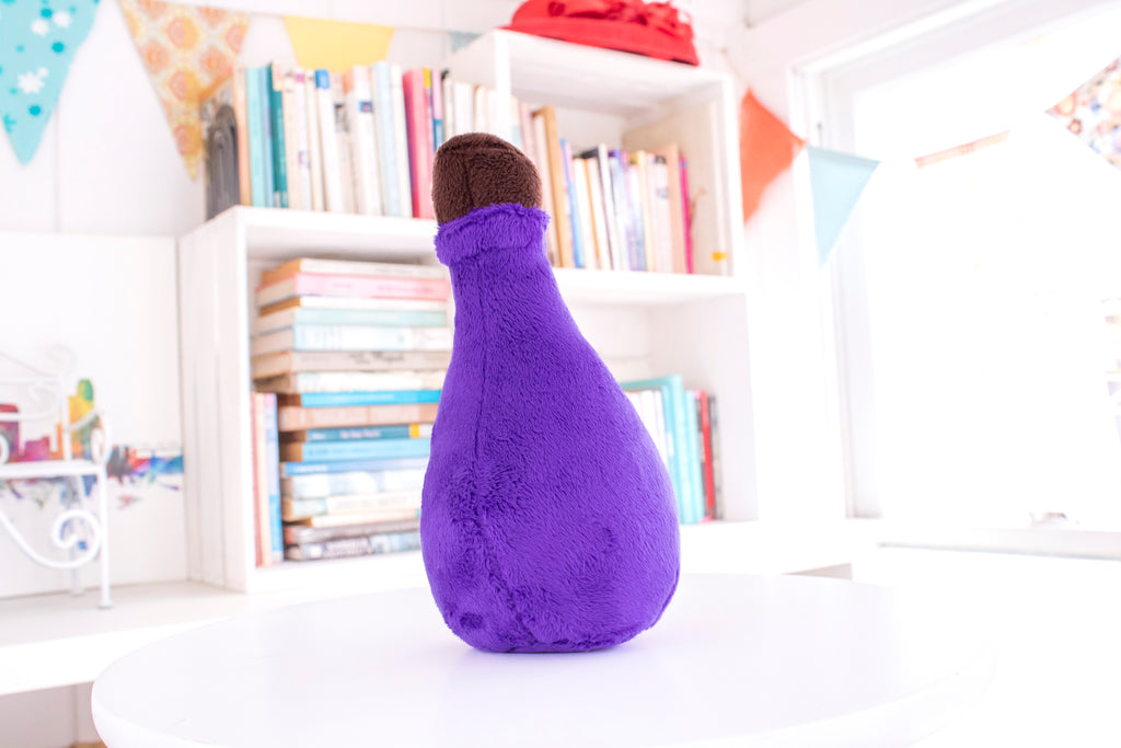 Purple teardrop shaped potion bottle plush toy with a brown top.